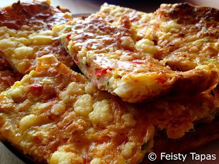 Slices of several slices of the Crustless cheesy vegetable, ham and anchovy pie