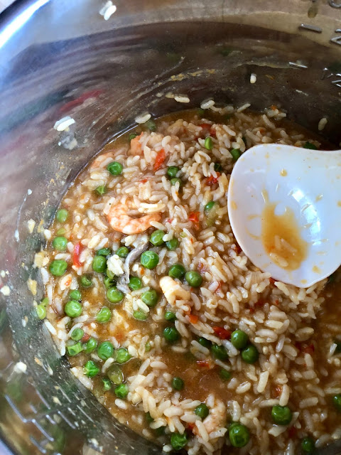 Instant Pot Prawn, Trout and Pea Risotto with the butter being stirred in. A Feisty Tapas recipe. Pressure cooker risotto with arborio rice, peas, prawns, trout Instant Pot Prawn, Trout and Pea Risotto served on a white plate. A Feisty Tapas recipe. Pressure cooker risotto with arborio rice, peas, prawns, trout