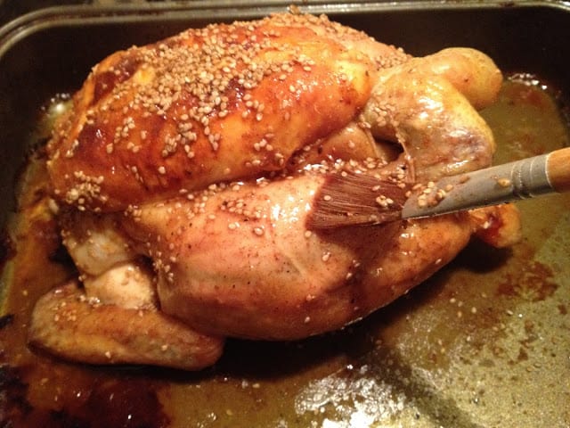 Maple-Glazed Roast Chicken with Sesame Seeds Maple-Glazed Roast Chicken with Sesame Seeds - Glazing with a brush