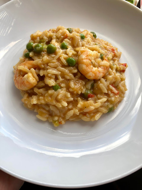 Instant Pot Prawn, Trout and Pea Risotto served on a white plate. A Feisty Tapas recipe. Pressure cooker risotto with arborio rice, peas, prawns, trout Instant Pot Prawn, Trout and Pea Risotto