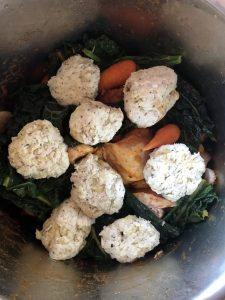 Photo of the ingredients for the Chicken Stew with Suet-Free Dumplings about to be pressure cooked. All the ingredients are in: chicken thigh fillets, carrots, cavolo nero, dumplings, etc. in the Instant Pot DUO's stainless steel inner pot. Ready to be pressure cooked