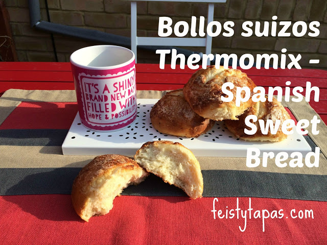 Bollos suizos and medias noches - Spanish sweet bread in the Thermomix - A bit like brioche. Show on a red table with a red beige and grey striped fabric placemat. Perfect with a coffee. Your Thermomix will make light work of this. Or of course you could knead it by hand Bollos suizos and medias noches - Spanish sweet bread in the Thermomix