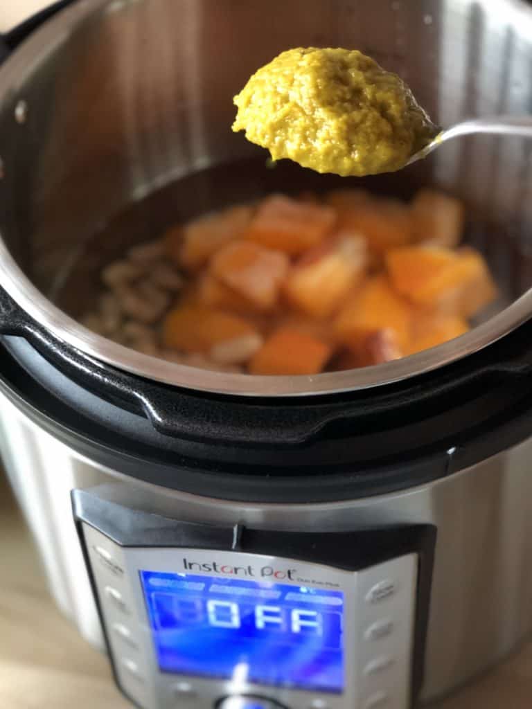Vegetable Stock Paste being added to Instant Pot Duo Evo Plus Cavolo Nero and Buttternut Squash soup