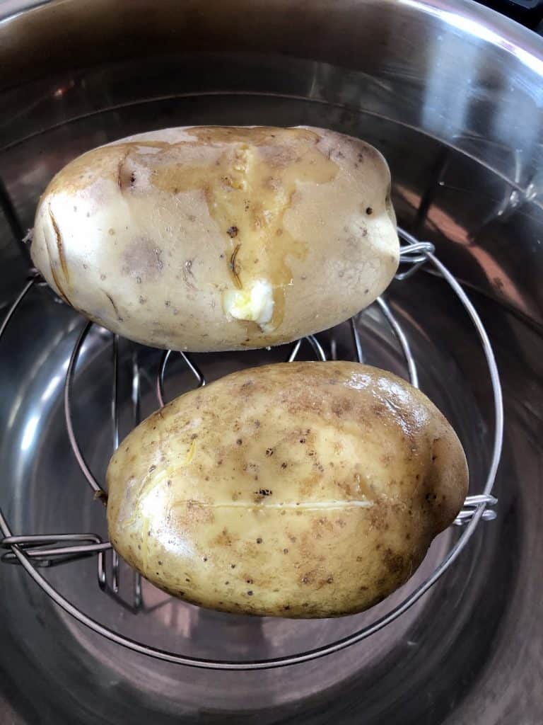 Butter on baking potatoes and ready to crisp up
