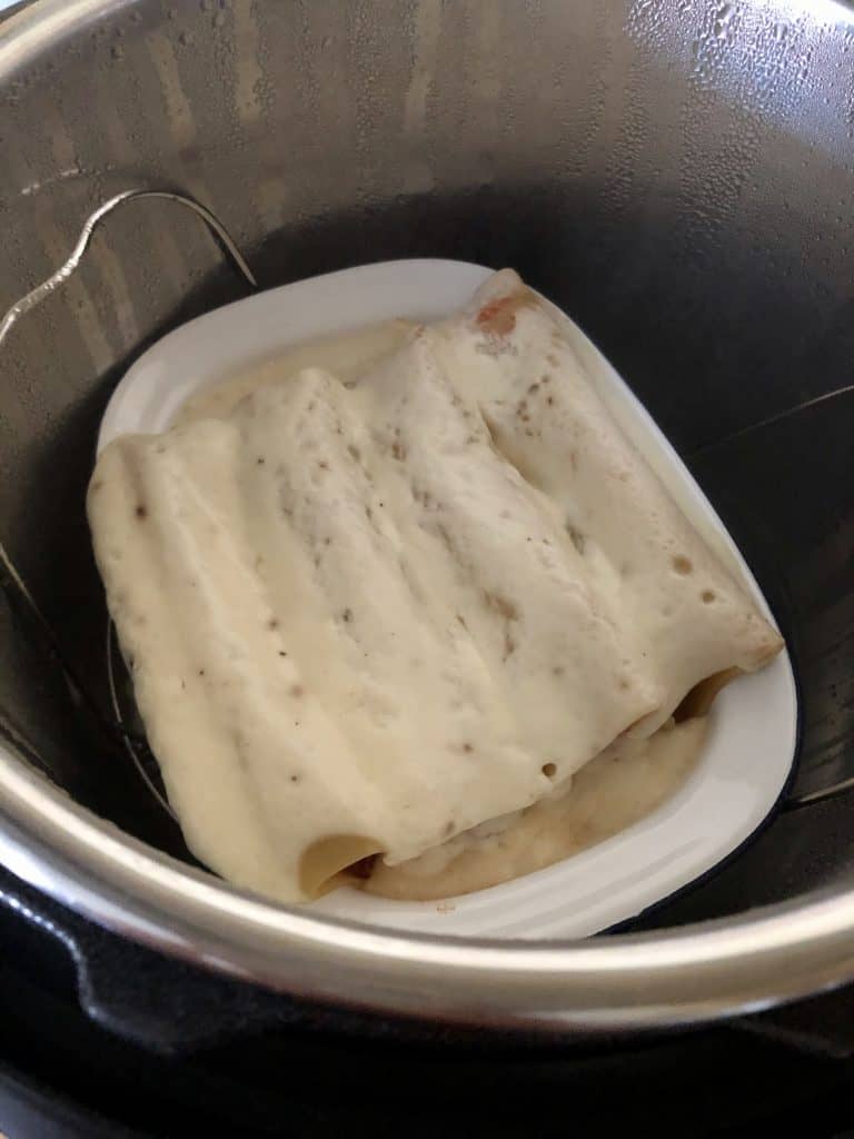 Cannelloni just cooked, just after opening the lid. You can also pressure cook them with more of the tuna and tomato sauce mix on top rather than white sauce / béchamel, which you can save to the end