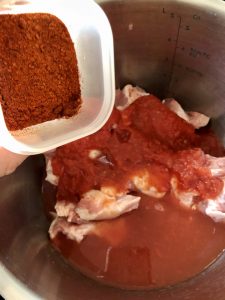Photo of the Paprika and salt being added to Easy Instant Pot BBQ Pulled Pork recipe by Feisty Tapas