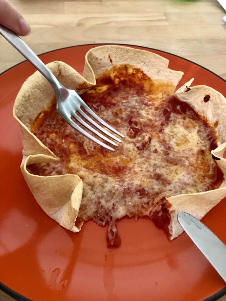 Digging into one of the tortilla wrap pizzas