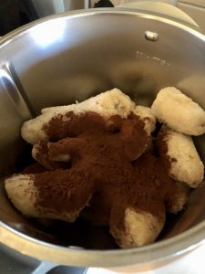 Frozen banana and cocoa powder in the Thermomix bowl ready to blend for step 1