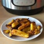 Photo of parsnips on a white plate in front of an Instant Pot Duo Crisp