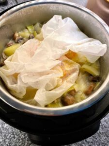 Pressure Cooker Leek Risotto with Sea Bass - right after QPR. The fish is still in the greaseproof paper in the parcel