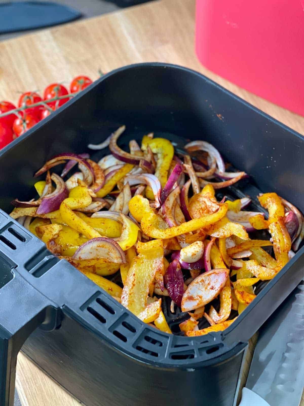 Sliced pepper, red onion, garlic etc seen in Instant Vortex 4 in 1 drawer from above