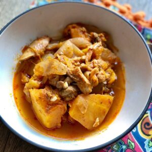 Photo of the chicken and butternut squash served in a bowl, seen close up from above