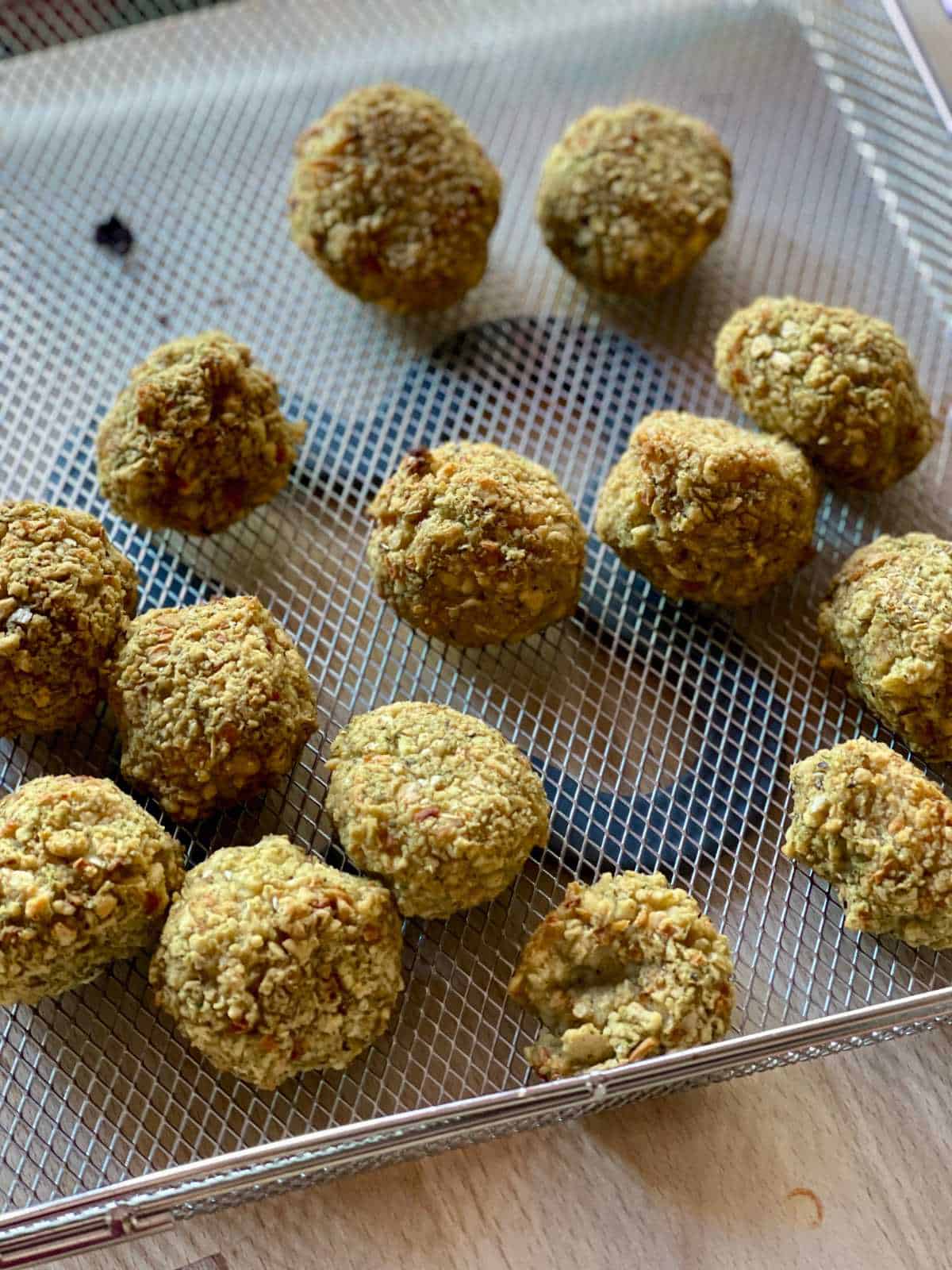 Photo of Balls of Paxo Sage and Onion Stuffing in the basket of the Ninja 8 in 1 Mini Flip Oven