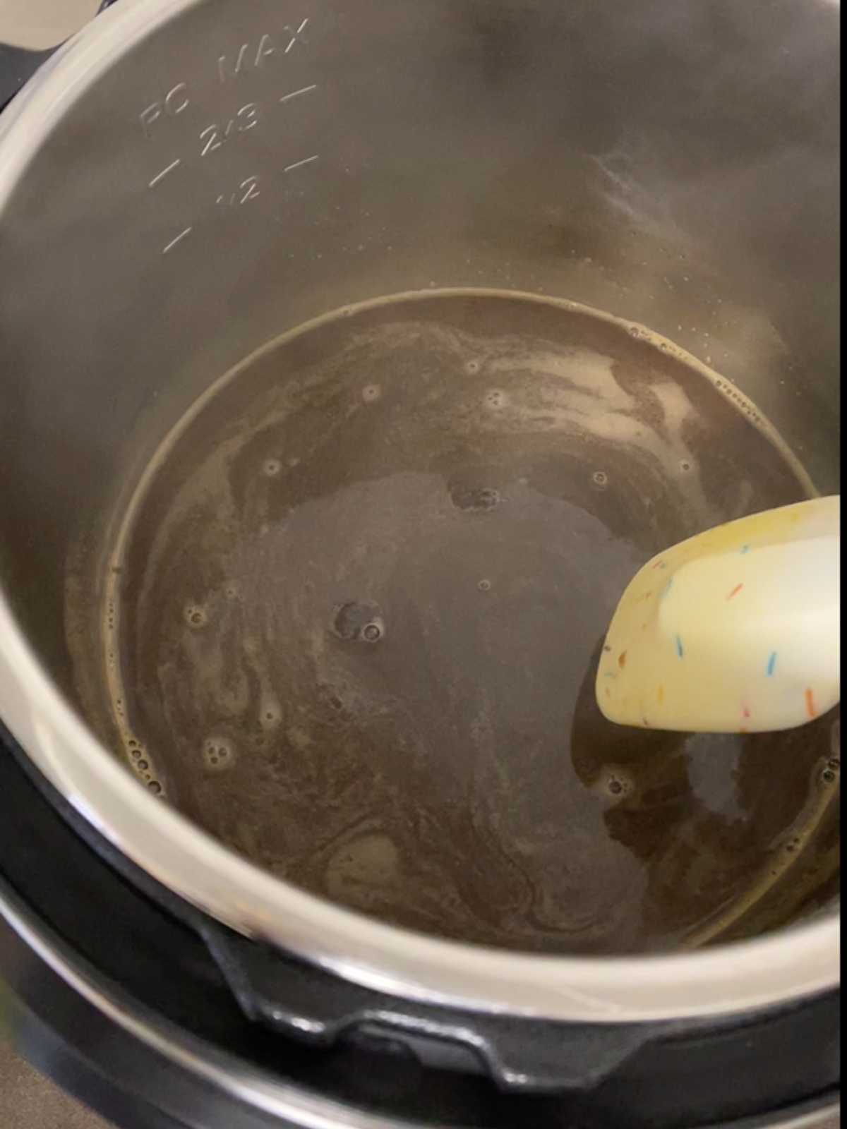 Photo of the sugar dissolving into the liquid in step one