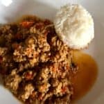 The mince served with a nice round block of the cooked rice on a white plate, get ready to dig in