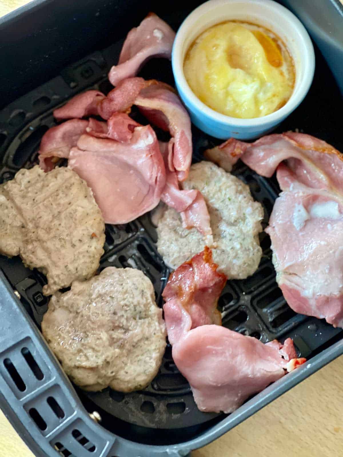 Photo taken right after flipping the bacon and the patties, the bacon is no longer on the patties as there's space and this way they can brown. No need to flip the egg