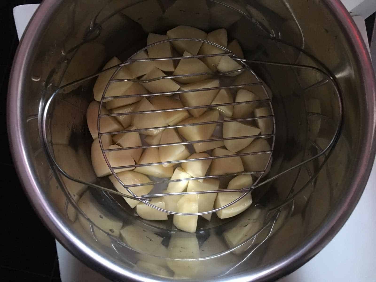 Photo of the potato layer with the trivet / steam rack on top