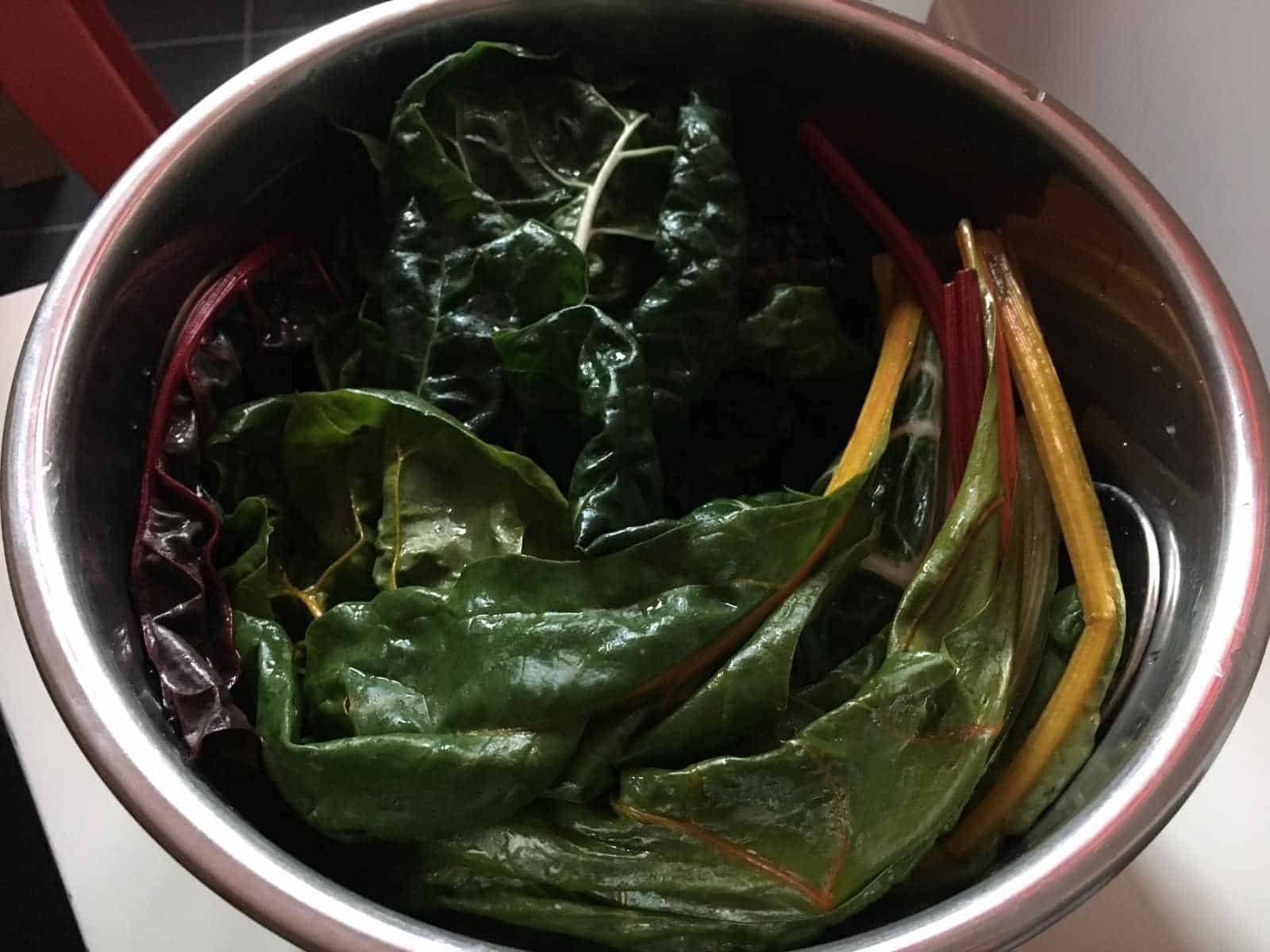 Photo of the chard layer before pressure cooking, it sits on top of the potatoes