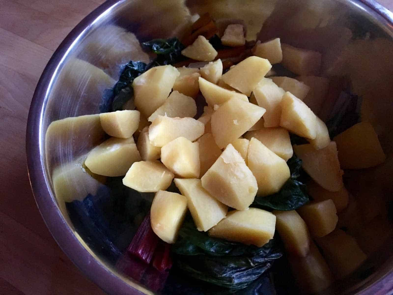 Photo of the pressure cooked and drained chard and potatoes ready to mix with the olive garlic and paprika