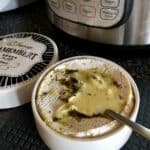 A round camembert cheese wheel pressure cooked melting and ready to dip into