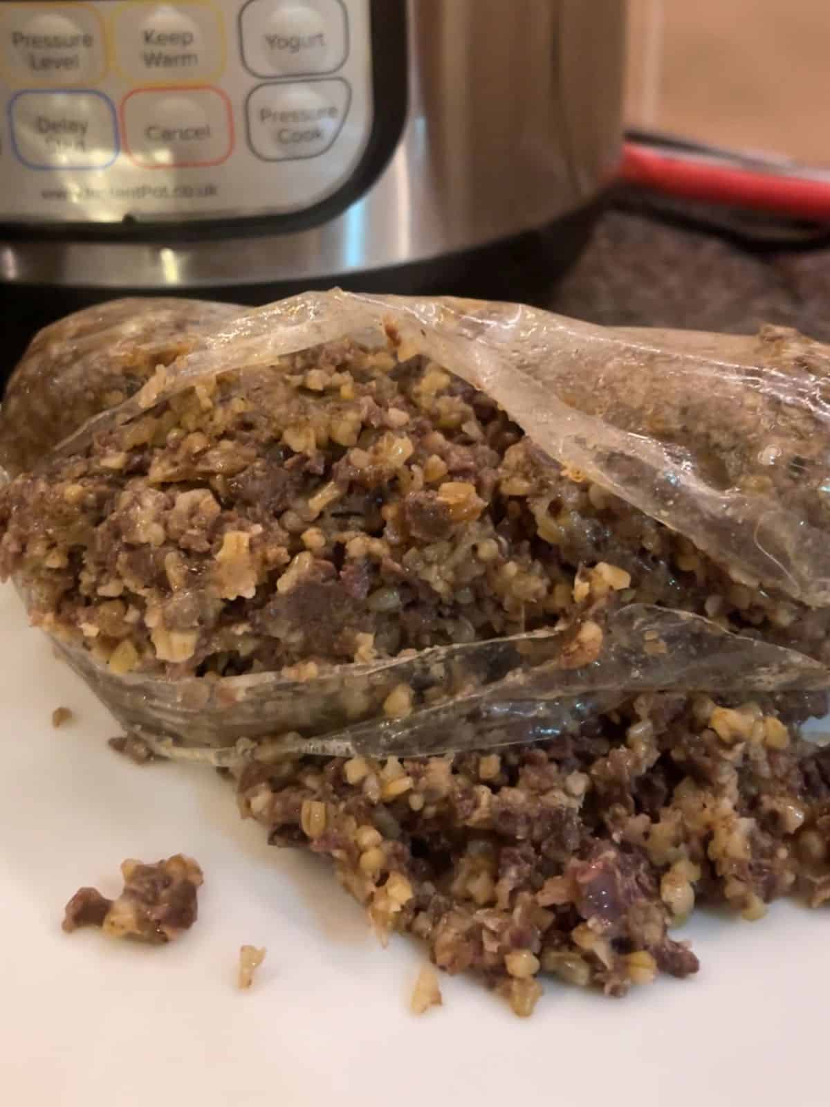 Photo of a Haggis after pressure cooking, seen bursting out of the film