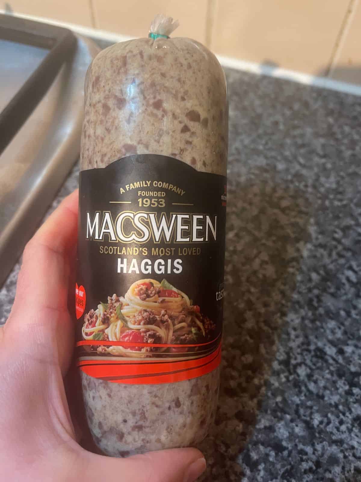 Photo of a MACSWEEN Haggis with a hand holding it