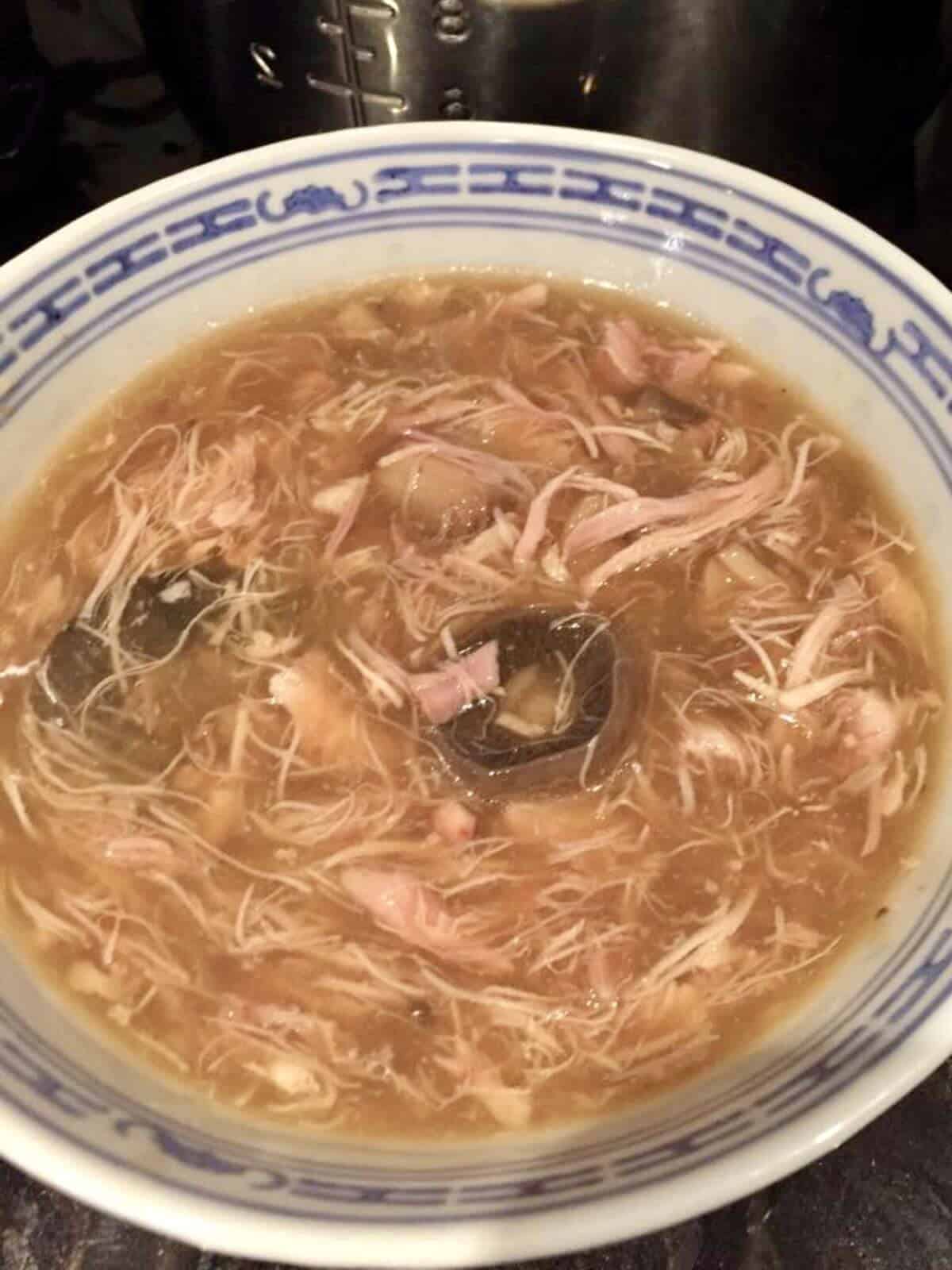 Photo of Helen's own pressure cooked chinese chicken and mushroom seen in an oriental style white bowl with blue trim