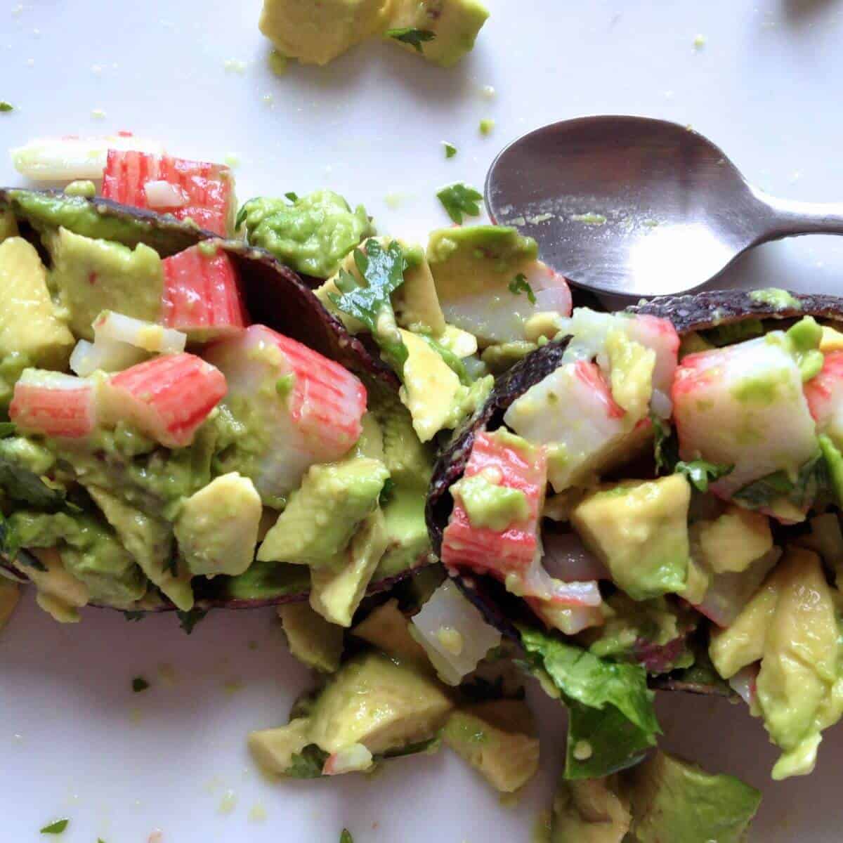 Image of the avocado and seafood stick mix deliciously spilling out of the avocado shells