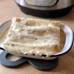 Tuna cannelloni ready to eat inside an oblong white enamel dish with dark rim