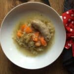 The sausage and apple casserole served on a white plate, should you need a good giggle it might be handy to know that the sausage looks rather phallic