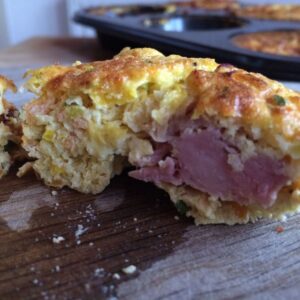 One of the Thermomix Ham Hock Egg Muffins sliced open with a nice chunk of ham on show