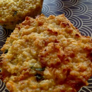 Two quinoa muffins ready to eat served on a tray with a seventies grey and white pattern