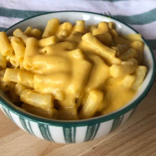 Thermomix Vegan Mac and Cheese served in a white bowl with green stripes on the outside