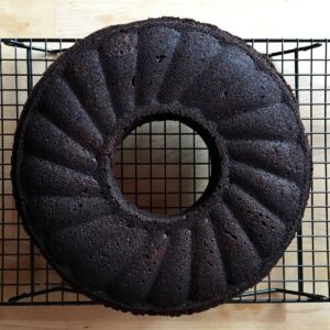 Chocolate beetroot ring cake sitting on a cooling rack