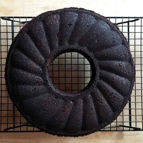Chocolate beetroot ring cake sitting on a cooling rack